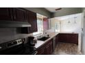 Updated kitchen with wood cabinets, tile backsplash, and a breakfast bar at 1592 Martin Luther King Ne Blvd, Winter Haven, FL 33881
