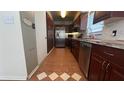 Kitchen with stainless steel appliances and dark wood cabinetry, ideal for cooking and storage at 1592 Martin Luther King Ne Blvd, Winter Haven, FL 33881