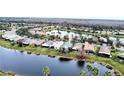 Aerial view of community with lake, lush landscaping, and various houses at 160 Rialto Rd, Poinciana, FL 34759