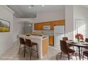 Eat-in kitchen with light wood cabinets and a breakfast bar at 1739 Morning Star Dr, Clermont, FL 34714