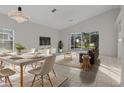 Bright living room with a dining area and access to backyard at 1739 Morning Star Dr, Clermont, FL 34714