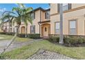 Two-story townhome with attractive landscaping and a paved driveway at 2143 Calabria Ave, Davenport, FL 33897