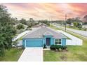 Single story home, blue exterior, white fence, and driveway at 233 Tiffany Ct, Kissimmee, FL 34758
