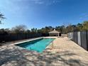Community pool with a fenced-in area and shaded seating at 2332 Prime Cir # B, Kissimmee, FL 34746