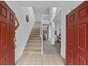 Bright entryway with staircase to the second floor at 256 Lancaster Dr, Davenport, FL 33897