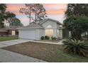 Charming one-story home features a two-car garage and well-maintained front lawn at 2993 Stillwater Dr, Kissimmee, FL 34743