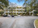 Building exterior showcasing a yellow three-story building with parking at 312 Lucaya Loop # B5/U312, Davenport, FL 33897