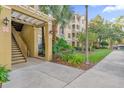 Condo building exterior showing walkway, stairs, and landscaping at 3326 Robert Trent Jones Dr # 10102, Orlando, FL 32835