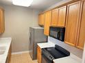 Condo kitchen with wood cabinets, stainless steel appliances, and light countertops at 3326 Robert Trent Jones Dr # 10102, Orlando, FL 32835