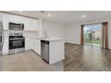Modern kitchen featuring stainless steel appliances and light cabinetry at 4078 Malawi Trl, Saint Cloud, FL 34772
