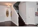 Inviting entryway showcases dark wood floors, a decorative front door, and a staircase at 4858 Stone Acres Cir, St Cloud, FL 34771