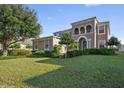 Charming two-story home featuring manicured landscaping, a well-maintained lawn and an elegant neutral color palette at 4858 Stone Acres Cir, St Cloud, FL 34771