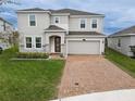 Two-story house with gray siding, stone accents, and a brick driveway at 5052 Center Ct, St Cloud, FL 34772
