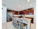 Spacious kitchen with stainless steel appliances and granite countertops at 524 Sardinia Cir, Davenport, FL 33837