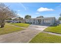 A house with a large yard and driveway at 7804 Acadian Dr, Orlando, FL 32822