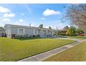 Ranch home with a landscaped yard and driveway at 7804 Acadian Dr, Orlando, FL 32822