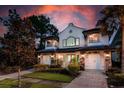 Two-story house with stone accents, two-car garage, and landscaped yard at 8162 Valhalla Ter, Reunion, FL 34747