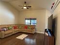 Bright living room with hardwood floors and sectional sofa at 26 Lake Diamond Ave, Ocala, FL 34472