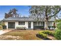 Newly remodeled home with white and gray exterior at 110 E Palmetto Ave, Howey In The Hills, FL 34737