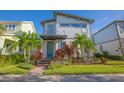 Modern two-story house with teal door and landscaped yard at 13135 Granger Ave, Orlando, FL 32827