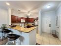 Kitchen with granite countertops, stainless steel appliances, and breakfast bar at 1361 Tuscan Ter # 7305, Davenport, FL 33896