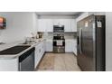 Modern kitchen with stainless steel appliances and white cabinets at 1956 Egret Meadows Ave, Kissimmee, FL 34744