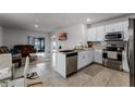 Open concept kitchen and living area with modern finishes at 1956 Egret Meadows Ave, Kissimmee, FL 34744