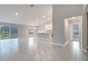 Open floor plan living room with tile floors and sliding glass doors at 22 Peterlee Ct, Kissimmee, FL 34758