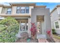 Modern two-story townhome with stone accents and a landscaped front yard at 2274 Centerra Loop, Kissimmee, FL 34741
