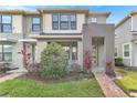 Modern two-story townhome featuring stone accents and a welcoming front entrance at 2274 Centerra Loop, Kissimmee, FL 34741