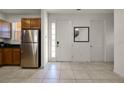 Bright and airy entryway with tile floors and kitchen access at 2621 Bugatti Ct, Kissimmee, FL 34746