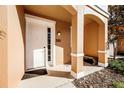 Front entrance of townhome with white door and covered porch at 2621 Bugatti Ct, Kissimmee, FL 34746