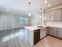 Modern kitchen with gray cabinets, quartz countertops, and stainless steel appliances at 272 Muscogee Ln, Orlando, FL 32825