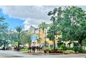 Hotel exterior showcasing landscaping and signage at 3000 Maingate Ln # 228, Kissimmee, FL 34747