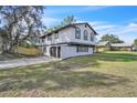 Two-story home with an attached two-car garage and a spacious, grassy lawn at 3020 Rockingham Cir, Orlando, FL 32808