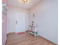 Bright entryway with wood-look floors and decorative accents at 3643 Julius Estates Blvd, Winter Haven, FL 33881