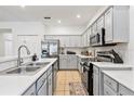 Modern kitchen with stainless steel appliances and white cabinets at 384 Orange Cosmos Blvd, Davenport, FL 33837