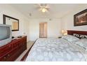 Main bedroom with a large bed, dresser and en-suite bathroom at 4105 Tropical Isle Blvd # 216, Kissimmee, FL 34741