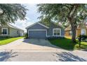 House exterior showcasing a gray painted facade and a driveway at 435 Madina Cir, Davenport, FL 33837