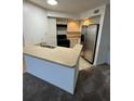 Condo kitchen with stainless steel appliances and light cabinets at 4518 Commander Dr # 1918, Orlando, FL 32822