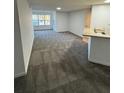 Bright and airy living room with grey carpet and view to exterior at 4518 Commander Dr # 1918, Orlando, FL 32822