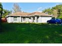 Single-story home featuring a gray exterior, attached garage, and a spacious front yard at 500 16Th St, Saint Cloud, FL 34769