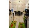Bright kitchen with granite countertops, white cabinets, and a dining area at 500 16Th St, Saint Cloud, FL 34769