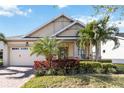 Single-story home with a welcoming porch and attractive facade at 5014 E Fountainwood Dr, Saint Cloud, FL 34772
