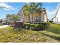 Charming curb appeal, lush landscaping, and a welcoming entrance at 5014 E Fountainwood Dr, Saint Cloud, FL 34772