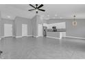 Open concept kitchen with white cabinets, granite countertops, and stainless steel appliances at 534 Bristol Cir, Kissimmee, FL 34758
