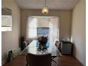 Dining room features a glass-top table and bay window at 648 Tradewinds Dr, Deltona, FL 32738