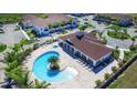 Aerial view of community pool with lounge chairs and clubhouse at 8906 Shine Dr, Kissimmee, FL 34747