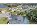 Aerial view of a home with solar panels, a screened-in pool, and a large body of water at 918 San Paulo Way, Kissimmee, FL 34758