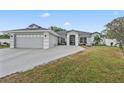 Charming home with a gray garage door, fountain, and a well manicured lawn at 918 San Paulo Way, Kissimmee, FL 34758